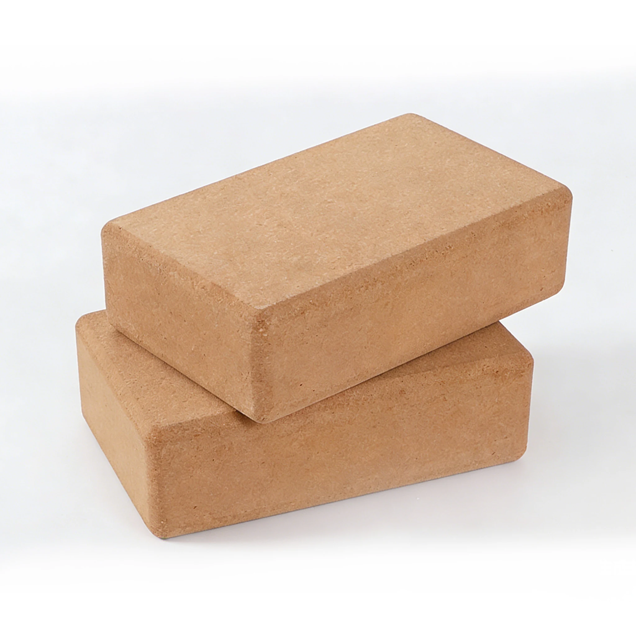Two natural cork yoga blocks stacked together